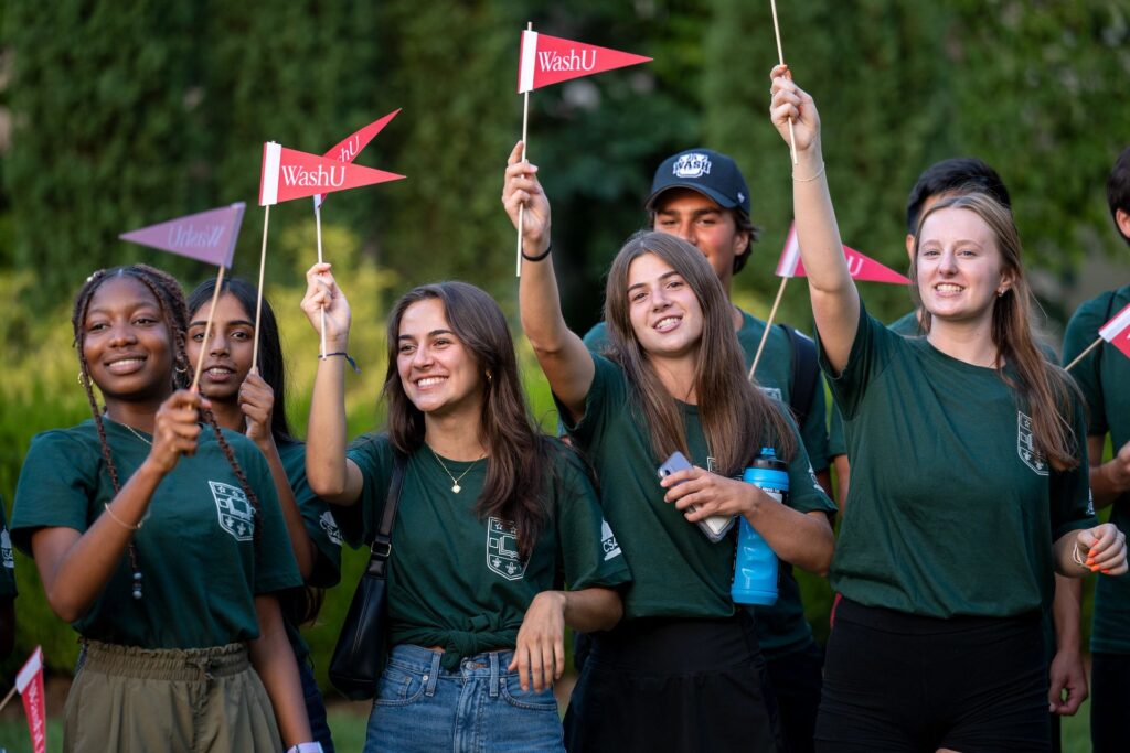 Students wave WashU flags during Convocation, marking the start of the academic year